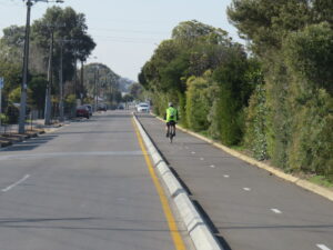 Separated bike lanes with vegetation screening the train line [2020]