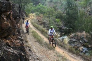 Cyclists riding the rail corridor above Eureka Creek
