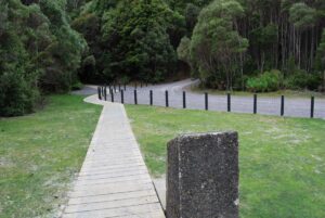 Looking toward the tunnel on the left and access road on the right. The commemorative plaque is in the foreground. (Dec 2010)