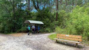 Walkers check their progress out of the sun at information shelter [2023]