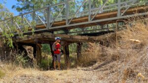 The Parsons Gully bridge, near Heathcote, slowly collapsing under its steel replacement [2025]
